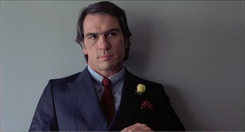 Movie still from “Stormy Monday” (1988), directed by Mike Figgis – A person wearing a suit and tie; Close Up shot, Low angle