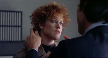 Movie still from “Stormy Monday” (1988), directed by Mike Figgis – A woman with red hair is looking at a man; Close Up shot, Over the shoulder angle