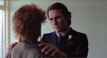 Movie still from “Stormy Monday” (1988), directed by Mike Figgis – A man in a suit and tie looking at a woman in a suit and tie; Close Up shot, Over the shoulder angle