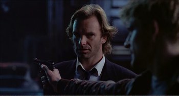 Movie still from “Stormy Monday” (1988), directed by Mike Figgis – A person holding a cell phone; Close Up shot, Over the shoulder angle