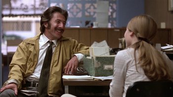 Movie still from “Straight Time” (1978), directed by Ulu Grosbard – A man sitting at a table talking to a woman; Medium shot, Over the shoulder angle