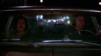 Movie still from “Straight Time” (1978), directed by Ulu Grosbard – Two people are seen in the reflection of a car window at night; Medium shot, Low angle
