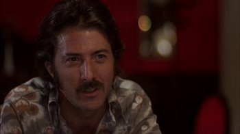 Movie still from “Straight Time” (1978), directed by Ulu Grosbard – A person with a mustache; Close Up shot, Low angle