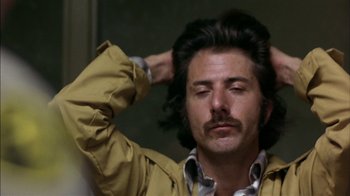 Movie still from “Straight Time” (1978), directed by Ulu Grosbard – A person holding his head; Close Up shot, Low angle