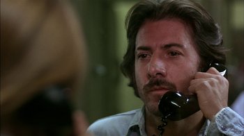 Movie still from “Straight Time” (1978), directed by Ulu Grosbard – A person talking on a phone; Close Up shot, Over the shoulder angle