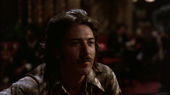 Movie still from “Straight Time” (1978), directed by Ulu Grosbard – A person sitting in a room; Close Up shot, Low angle