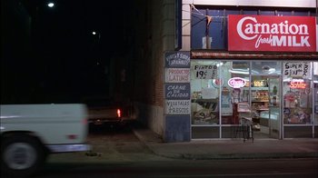 Movie still from “Straight Time” (1978), directed by Ulu Grosbard – A truck driving down a street past a restaurant; Wide shot, High angle