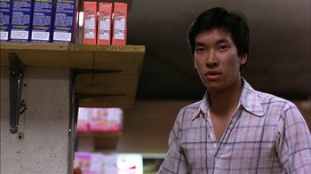 Movie still from “Straight Time” (1978), directed by Ulu Grosbard – A man standing in front of a shelf of food in a store; Close Up shot, Low angle