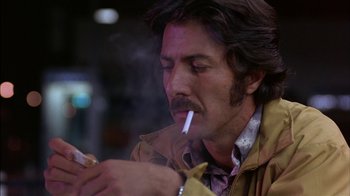 Movie still from “Straight Time” (1978), directed by Ulu Grosbard – A person smoking a cigarette; Close Up shot, Low angle