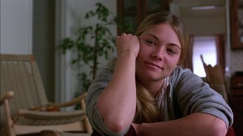 Movie still from “Straight Time” (1978), directed by Ulu Grosbard – A woman sitting on the ground with her arms crossed; Close Up shot, Low angle