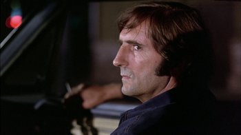 Movie still from “Straight Time” (1978), directed by Ulu Grosbard – A person with a cigarette in his mouth; Close Up shot, Low angle