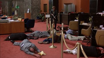 Movie still from “Straight Time” (1978), directed by Ulu Grosbard – A group of people laying on the ground in a room; Wide shot, High angle