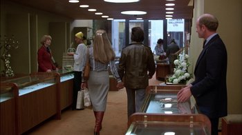 Movie still from “Straight Time” (1978), directed by Ulu Grosbard – Two people walking in a store holding hands; Wide shot, Over the shoulder angle