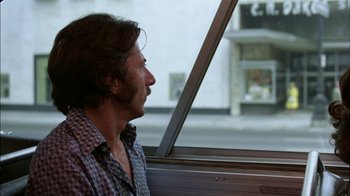 Movie still from “Straight Time” (1978), directed by Ulu Grosbard – A man looking out of a window on a bus; Close Up shot, Over the shoulder angle