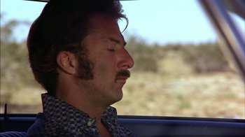 Movie still from “Straight Time” (1978), directed by Ulu Grosbard – A man sitting in a car looking out the window; Close Up shot, Low angle