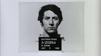 Movie still from “Straight Time” (1978), directed by Ulu Grosbard – A black and white photo of a man's mugshot; Close Up shot, Low angle