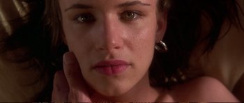 Movie still from “Strange Days” (1995), directed by Kathryn Bigelow – A woman's face with her hand on her chin; Extreme Close Up shot, Overhead angle