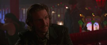 Movie still from “Strange Days” (1995), directed by Kathryn Bigelow – A person sitting in a room; Close Up shot, Over the shoulder angle