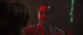 Movie still from “Strange Days” (1995), directed by Kathryn Bigelow – A man wearing a suit and a red tie; Close Up shot, Low angle