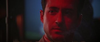 Movie still from “Strange Days” (1995), directed by Kathryn Bigelow – A man's face with red lighting; Close Up shot, Low angle