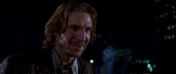 Movie still from “Strange Days” (1995), directed by Kathryn Bigelow – A person wearing a suit and tie; Close Up shot, Over the shoulder angle