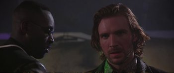 Movie still from “Strange Days” (1995), directed by Kathryn Bigelow – A man in a green shirt and a bald man in a green shirt; Close Up shot, Over the shoulder angle