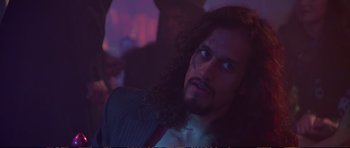 Movie still from “Strange Days” (1995), directed by Kathryn Bigelow – A person with long curly hair; Close Up shot, Low angle