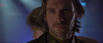 Movie still from “Strange Days” (1995), directed by Kathryn Bigelow – A man with long hair and green eyes; Close Up shot, Over the shoulder angle