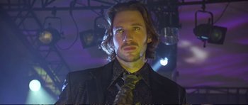 Movie still from “Strange Days” (1995), directed by Kathryn Bigelow – A person wearing a suit and tie; Close Up shot, Low angle