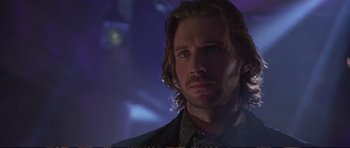 Movie still from “Strange Days” (1995), directed by Kathryn Bigelow – A man with long blonde hair stares into the distance; Close Up shot, Low angle