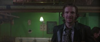 Movie still from “Strange Days” (1995), directed by Kathryn Bigelow – A man standing in front of a green wall; Close Up shot, Over the shoulder angle