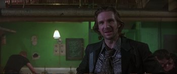 Movie still from “Strange Days” (1995), directed by Kathryn Bigelow – A man with long hair wearing a suit and tie; Close Up shot, Over the shoulder angle