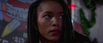 Movie still from “Strange Days” (1995), directed by Kathryn Bigelow – A person with long braids; Close Up shot, Low angle