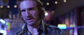 Movie still from “Strange Days” (1995), directed by Kathryn Bigelow – A person with long brown hair; Close Up shot, Over the shoulder angle