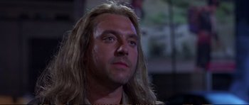 Movie still from “Strange Days” (1995), directed by Kathryn Bigelow – A person with long blonde hair; Close Up shot, Low angle