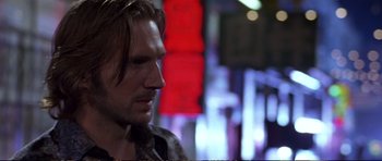 Movie still from “Strange Days” (1995), directed by Kathryn Bigelow – A person with long brown hair; Close Up shot, Over the shoulder angle