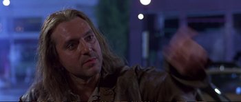 Movie still from “Strange Days” (1995), directed by Kathryn Bigelow – A person with long blonde hair; Close Up shot, Low angle