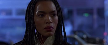 Movie still from “Strange Days” (1995), directed by Kathryn Bigelow – A person with long braids; Close Up shot, Low angle