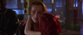 Movie still from “Strange Days” (1995), directed by Kathryn Bigelow – A man and a woman with red hair looking into each other's eyes; Close Up shot, Over the shoulder angle