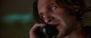 Movie still from “Strange Days” (1995), directed by Kathryn Bigelow – A person talking on a cell phone; Close Up shot, Low angle