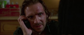 Movie still from “Strange Days” (1995), directed by Kathryn Bigelow – A person talking on a cell phone; Close Up shot, Low angle