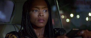 Movie still from “Strange Days” (1995), directed by Kathryn Bigelow – A person holding an open umbrella; Close Up shot, Low angle