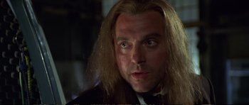 Movie still from “Strange Days” (1995), directed by Kathryn Bigelow – A person with long blonde hair; Close Up shot, Low angle