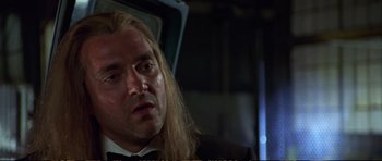Movie still from “Strange Days” (1995), directed by Kathryn Bigelow – A person wearing a suit and tie; Close Up shot, Low angle