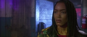 Movie still from “Strange Days” (1995), directed by Kathryn Bigelow – A man with braids is looking at the camera; Close Up shot, Low angle
