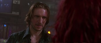 Movie still from “Strange Days” (1995), directed by Kathryn Bigelow – A person wearing a black shirt; Close Up shot, Over the shoulder angle