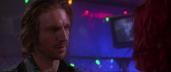 Movie still from “Strange Days” (1995), directed by Kathryn Bigelow – A person in a room with lights in the background; Close Up shot, Low angle