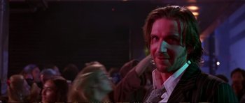 Movie still from “Strange Days” (1995), directed by Kathryn Bigelow – A person wearing a suit and tie; Close Up shot, Low angle