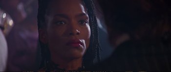 Movie still from “Strange Days” (1995), directed by Kathryn Bigelow – A person with braids looking at the camera; Close Up shot, Over the shoulder angle