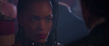 Movie still from “Strange Days” (1995), directed by Kathryn Bigelow – A person with dreadlocks looking at the camera; Close Up shot, Low angle